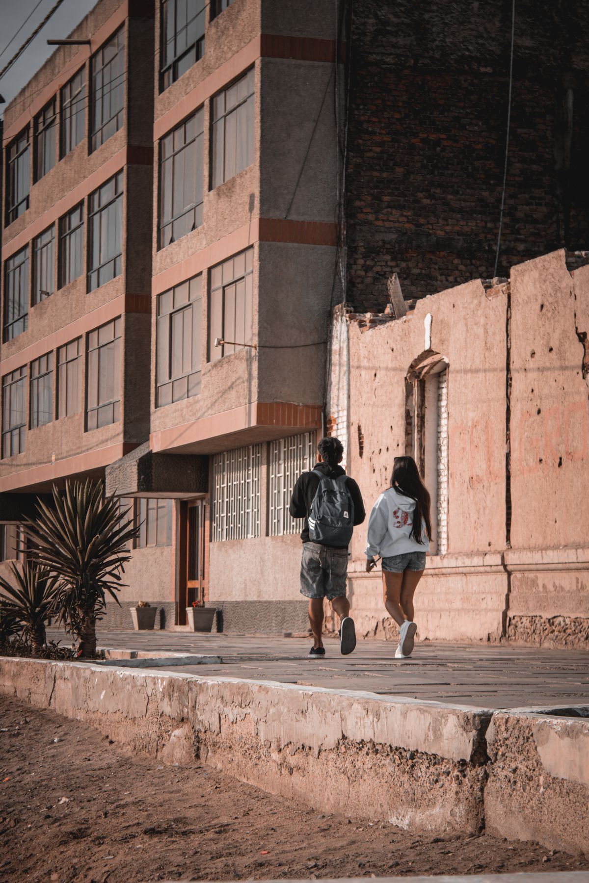 Two people walking across a street in a city · Free Stock Photo
