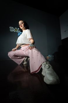 A young female dancer confidently posing indoors, showcasing contemporary style in Merida, Mexico.