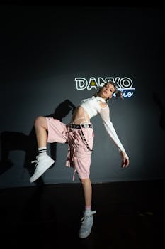 Female dancer striking a pose in a modern studio with dramatic lighting in Merida, Mexico.