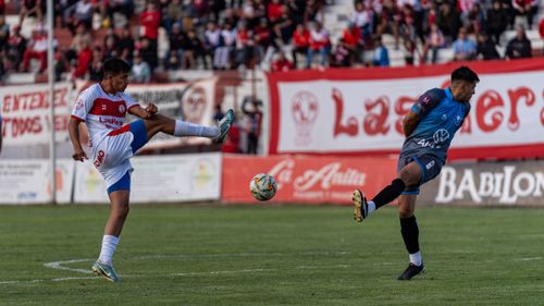 Free Dramatic soccer match action with players from opposing teams competing on the field. Stock Photo