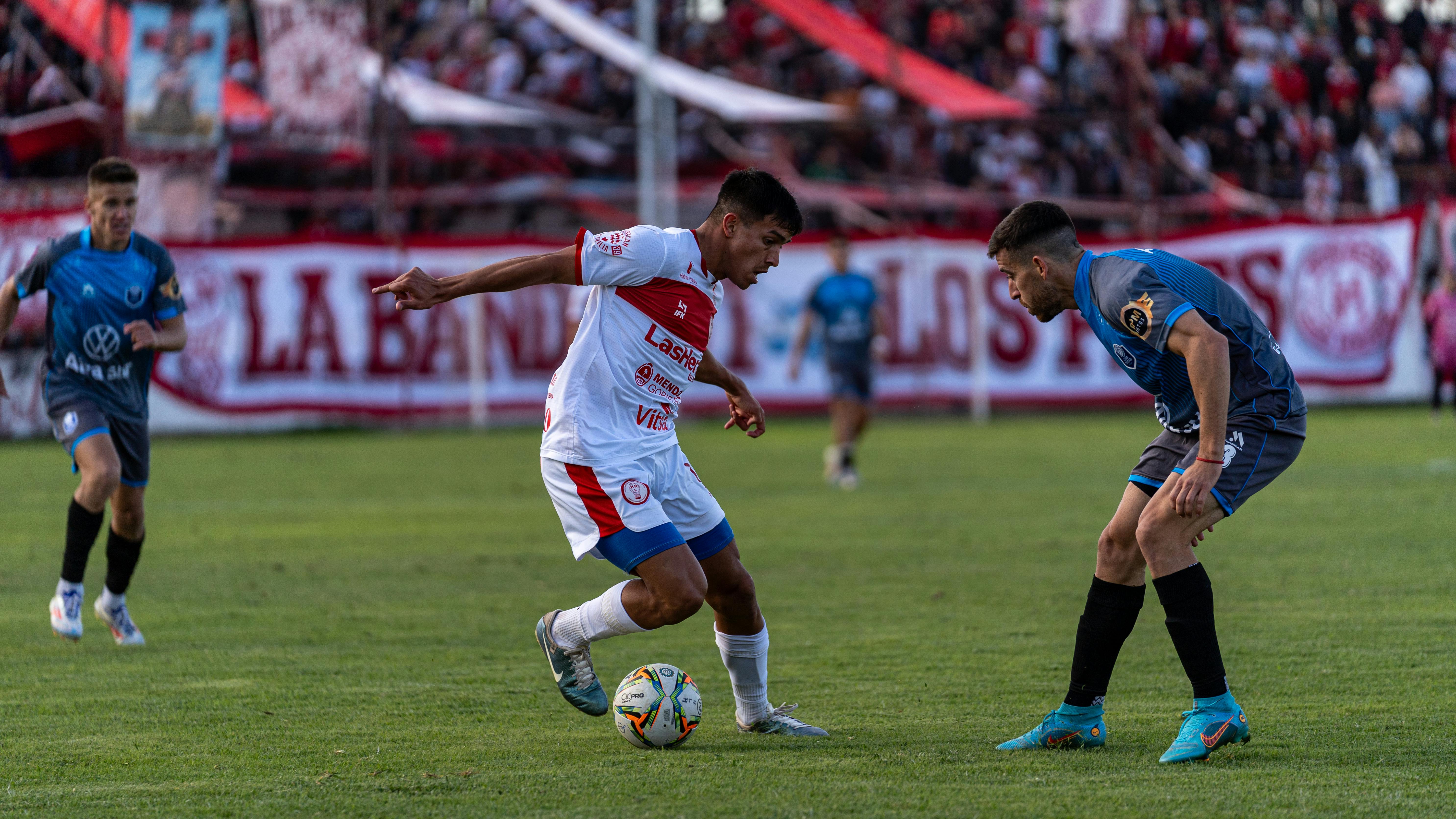 Exciting soccer match with players in action, showcasing skill and competition on the field.