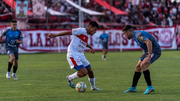Exciting soccer match with players in action, showcasing skill and competition on the field.