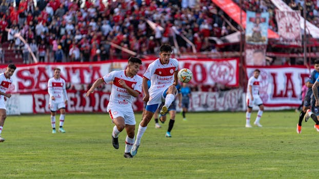 Captivating shot of players in a thrilling football match, showcasing dynamic action and teamwork.