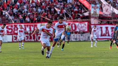 Free Captivating shot of players in a thrilling football match, showcasing dynamic action and teamwork. Stock Photo