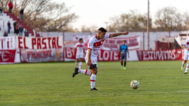 Football player in action during an outdoor match at a local stadium.