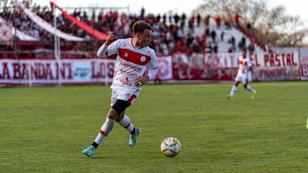 Exciting soccer match with players actively competing on the field, showcasing skill and team sportsmanship.