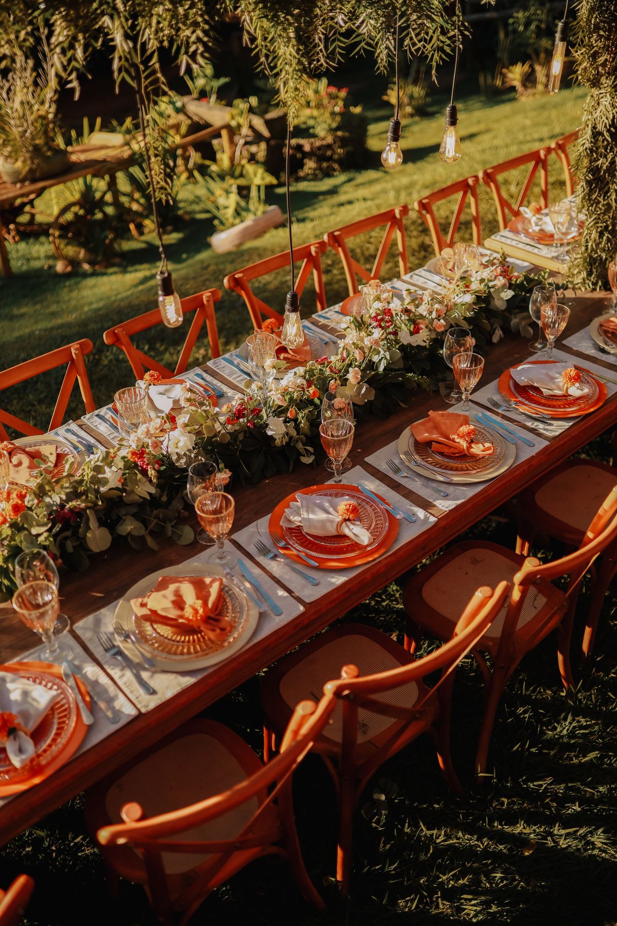 Beautifully arranged outdoor dining table with floral centerpiece, perfect for celebrations. Stock Photo.