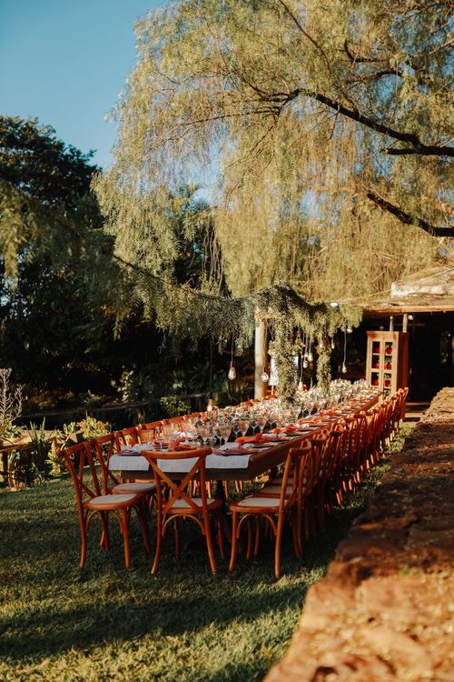 Free Beautiful outdoor garden setting with a long dining table, perfect for celebrations. Stock Photo