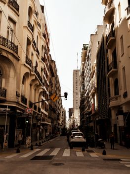 A bustling Brazilian street featuring classic architecture and urban life captured in warm tones.
