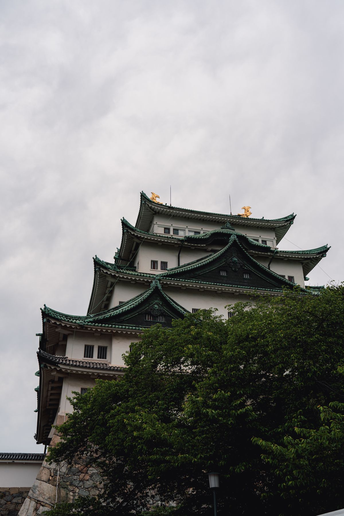 Majestic Nagoya Castle with traditional Japanese architecture under cloudy skies