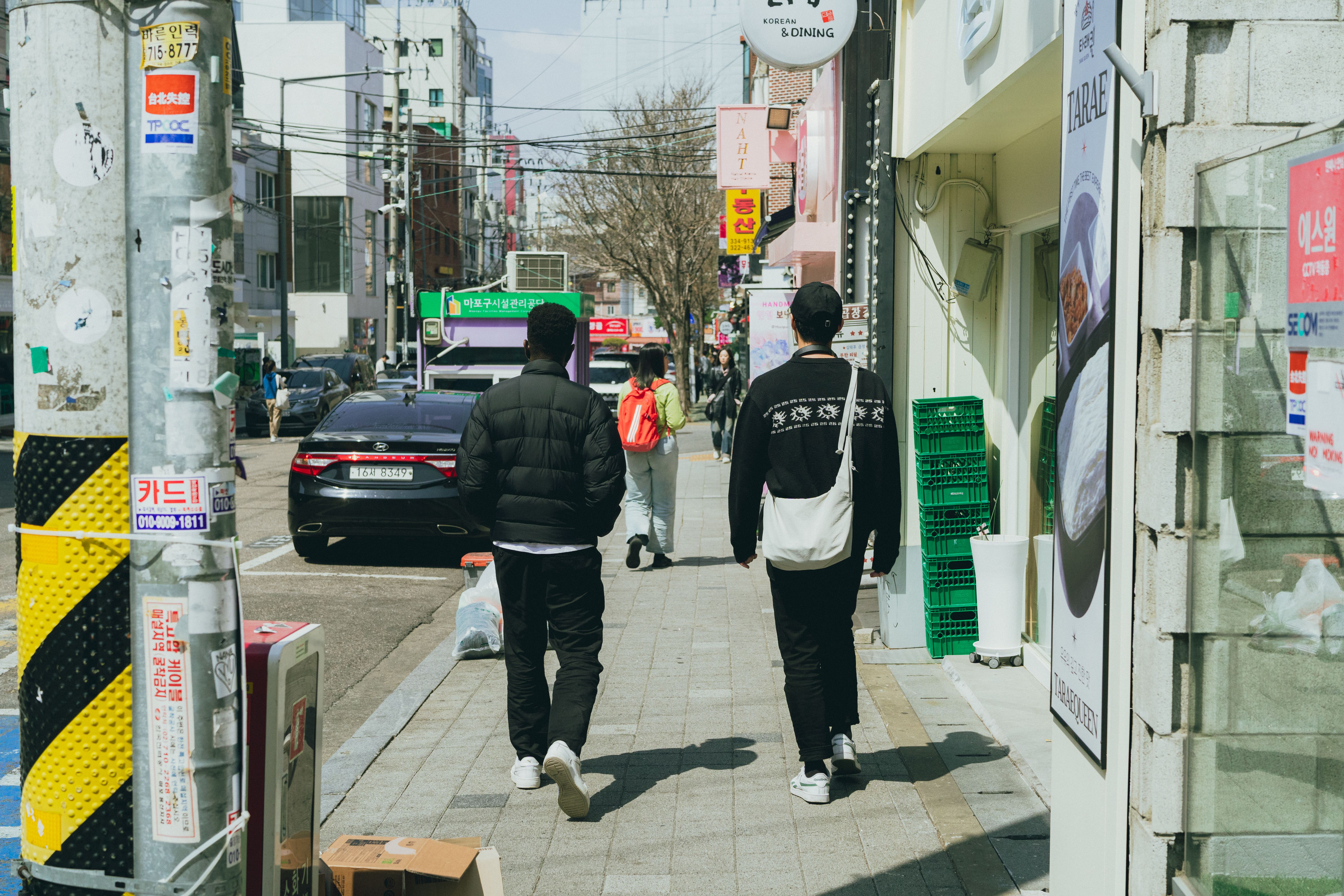 A vibrant street scene in Seoul, South Korea, showcasing daily urban life during spring.
