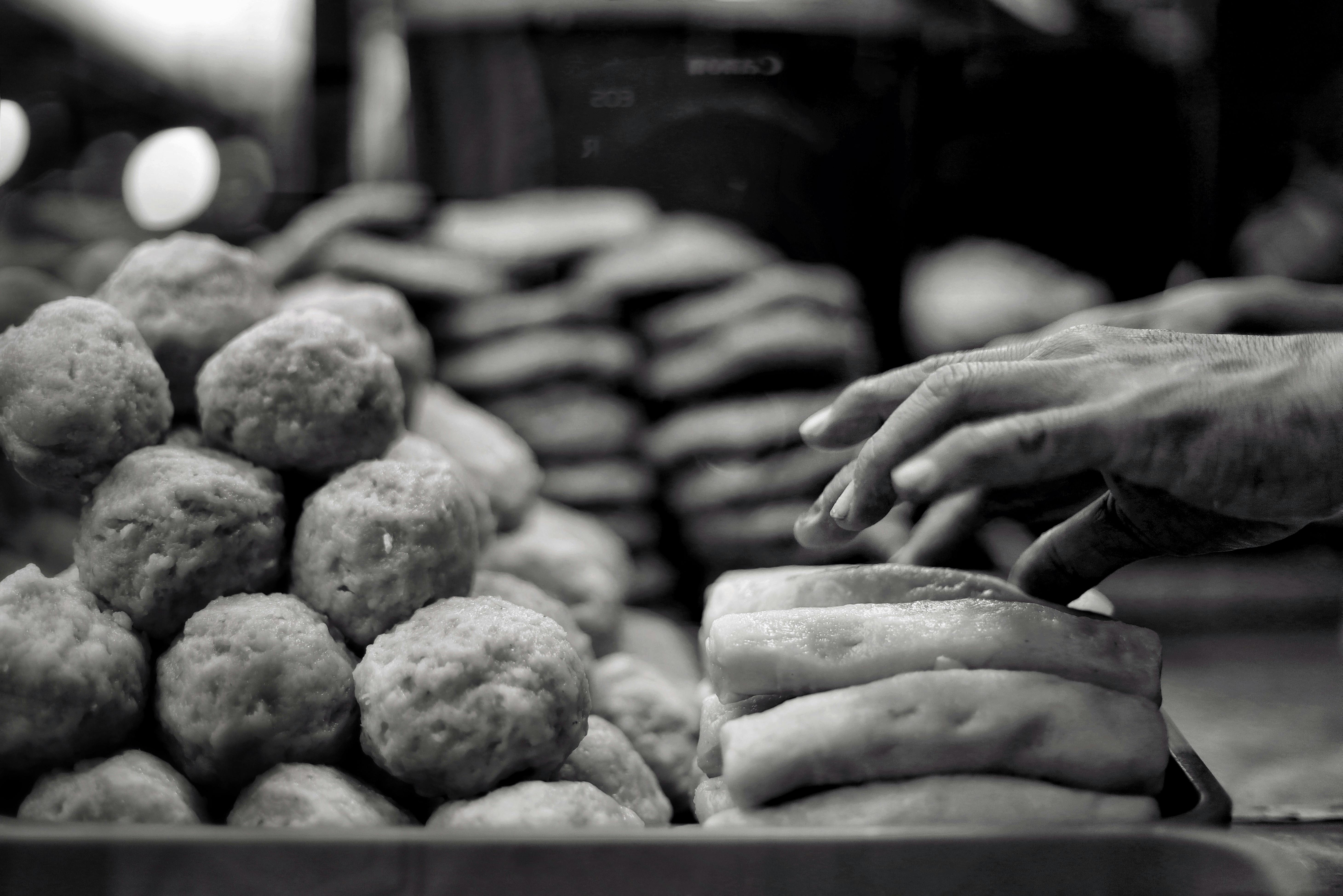Hand Arranging Bakery Goods in West Java Market · Free Stock Photo