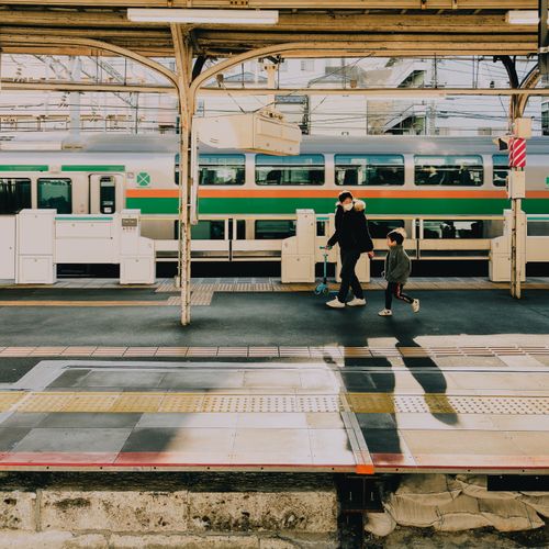 Free A father and son walk along the platform at a Tokyo train station during the early evening. Stock Photo