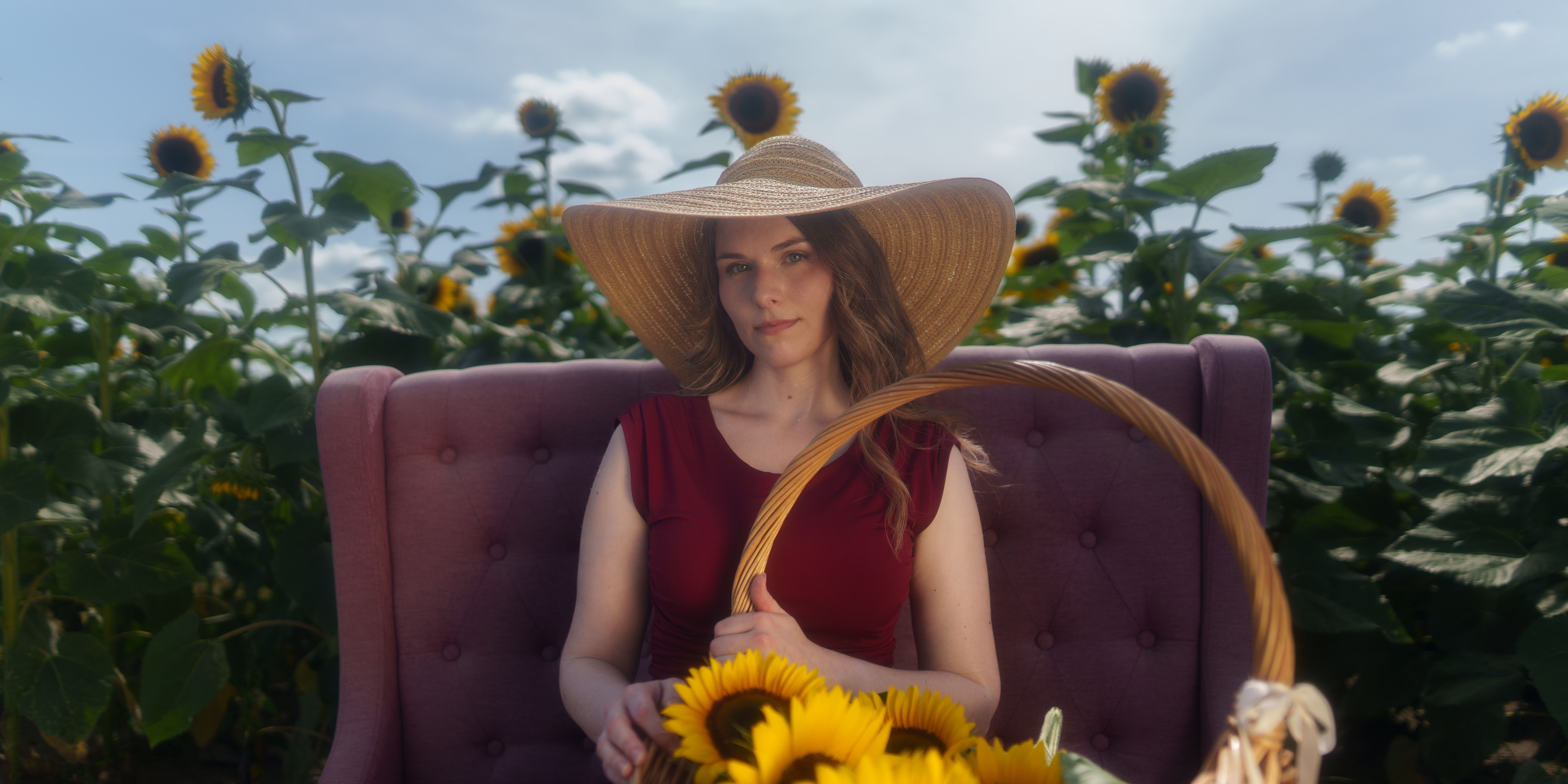 Woman in Sunflower Field with Elegant Hat · Free Stock Photo