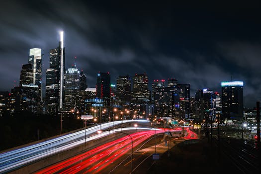 Dynamic cityscape at night showcasing light trails against a stunning skyline.