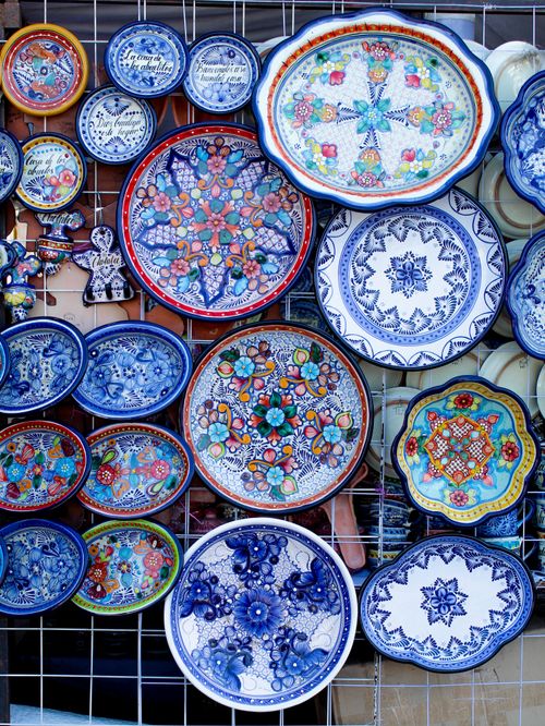 Free Vibrant hand-painted Mexican plates with traditional designs on display. Stock Photo