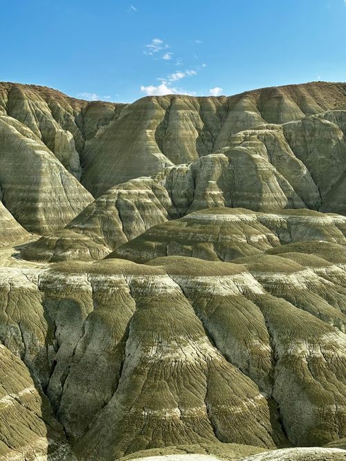 Free Eroded sedimentary formations in the badlands under a clear blue sky, showcasing rugged textures. Stock Photo