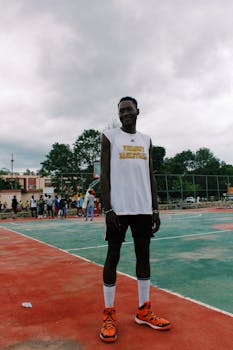 Tall athlete enjoying a game on an outdoor basketball court.