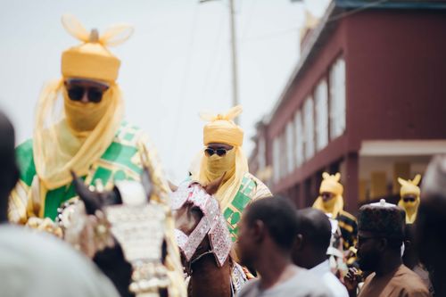 Free A vibrant Nigerian festival parade featuring people in traditional attire with horses. Stock Photo