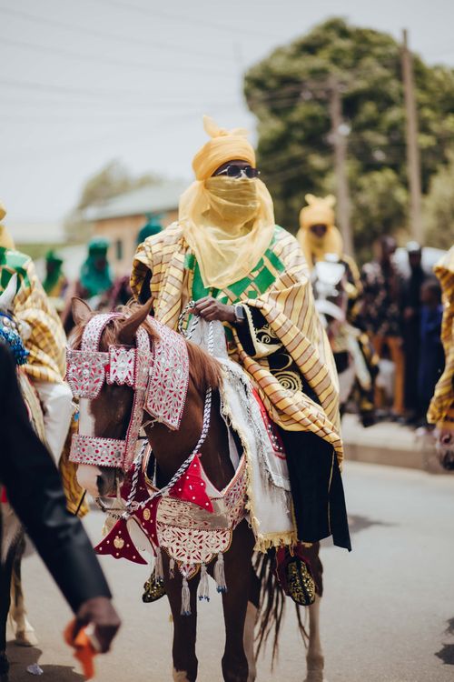 Free Colorful traditional parade in Nigeria featuring riders in ornate costumes on decorated horses. Stock Photo