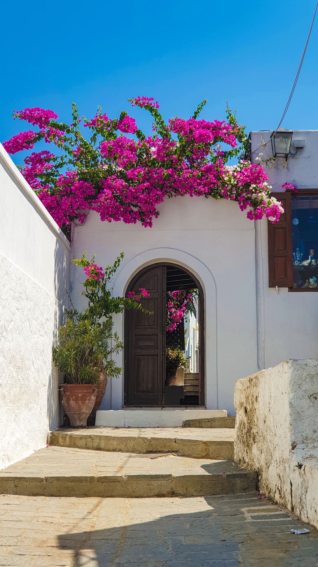 Mediterranean style home with stucco walls and bougainvillea, reference for Boca Lago architecture