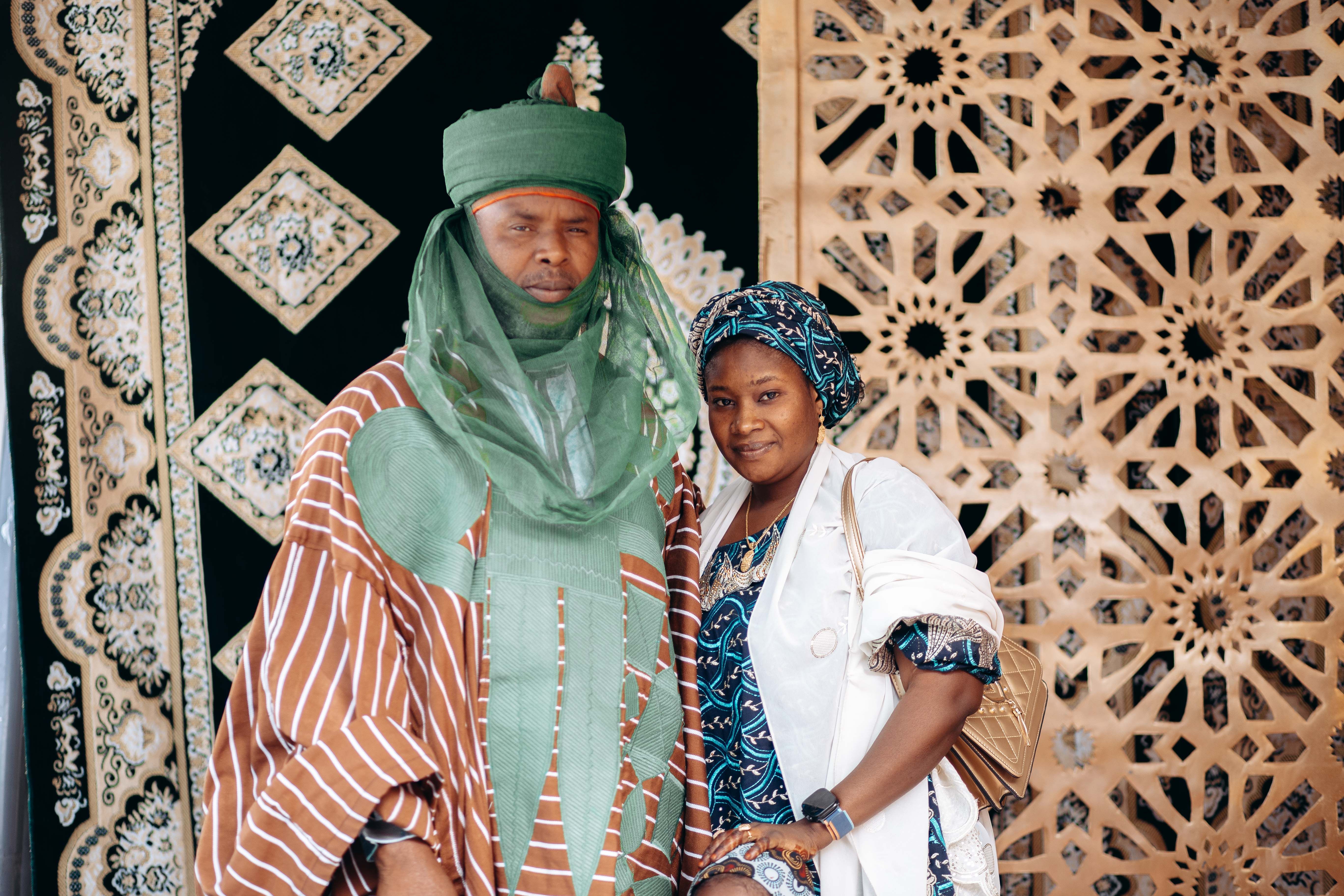 A couple in colorful traditional Nigerian clothing, showcasing rich cultural patterns and designs.