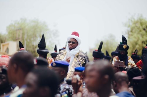 Free Group of adults in colorful traditional attire at a Nigerian ceremony outdoors. Stock Photo