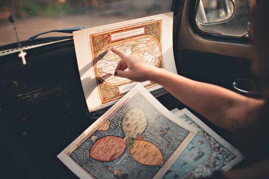 Person Inside A Vehicle Pointing On A Map 
