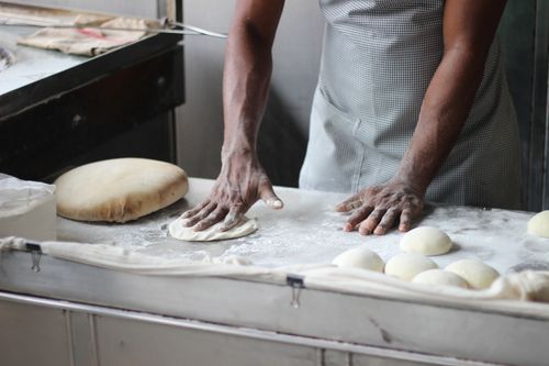 Baker preparing dough with precision measurements