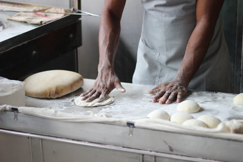 Baker preparing dough in kitchen — kitchen scale essential for baking