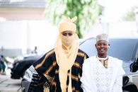 Two men in traditional Nigerian attire standing outdoors, showcasing vibrant cultural fashion.