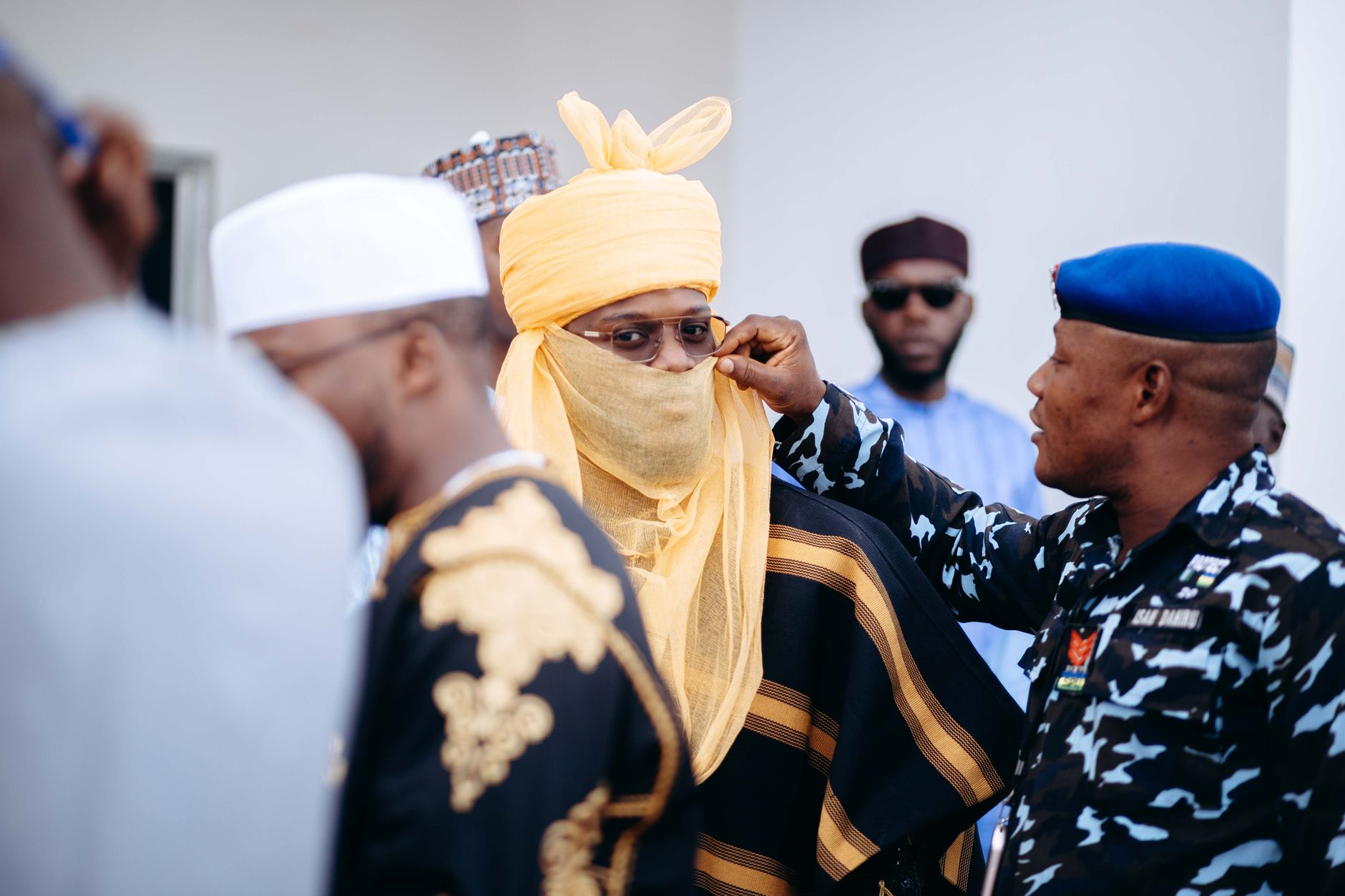 Men in traditional Nigerian attire during a cultural event highlighting diversity and tradition.
