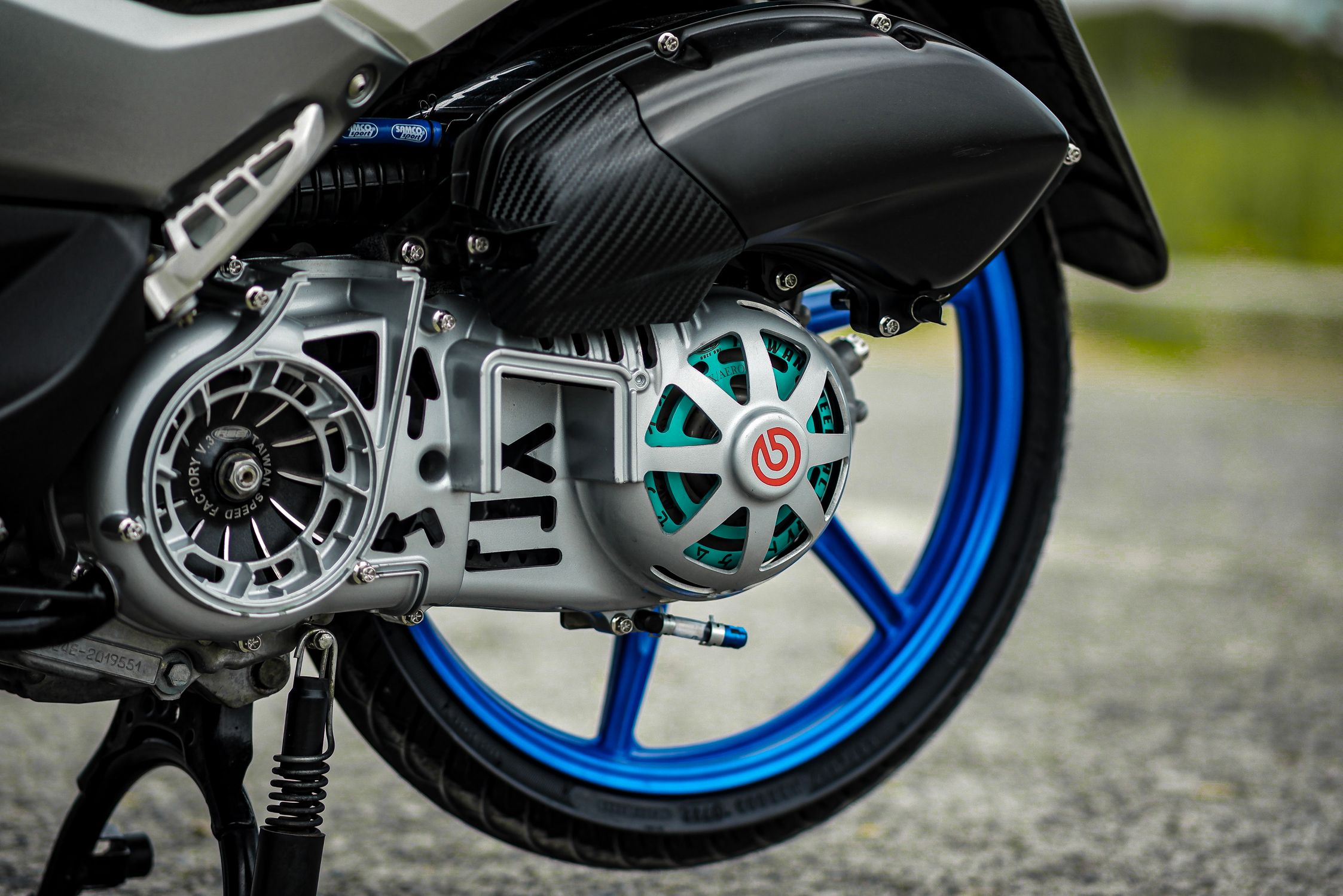 Close-Up of Motorcycle Engine and Blue Wheel · Free Stock Photo