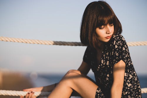 Free Woman Sitting Beside Ropes Stock Photo