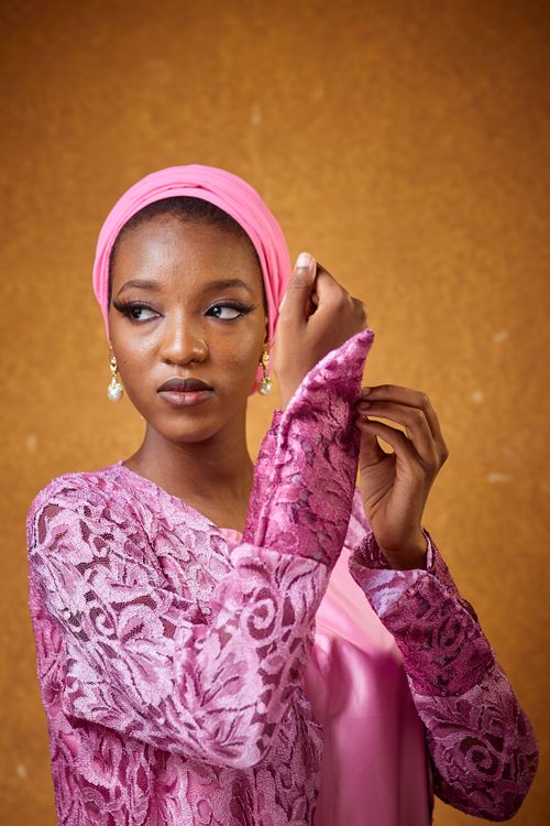 Elegant Woman in Pink Lace Attire Posing Gracefully · Free Stock Photo