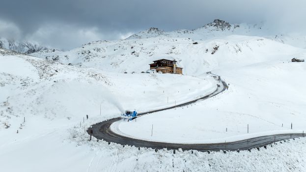 A stunning view of a snow-laden road winding through Heiligenblut, Austria.