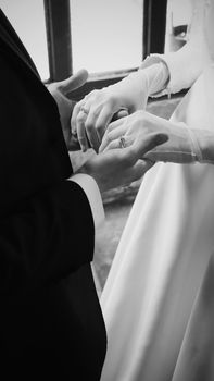 A timeless black and white photo capturing a bride and groom exchanging vows.
