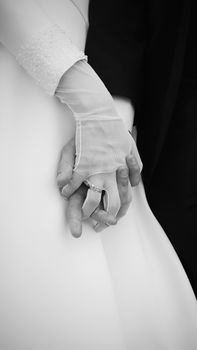 A romantic black and white shot of a couple holding hands on their wedding day in Bursa, Türkiye.
