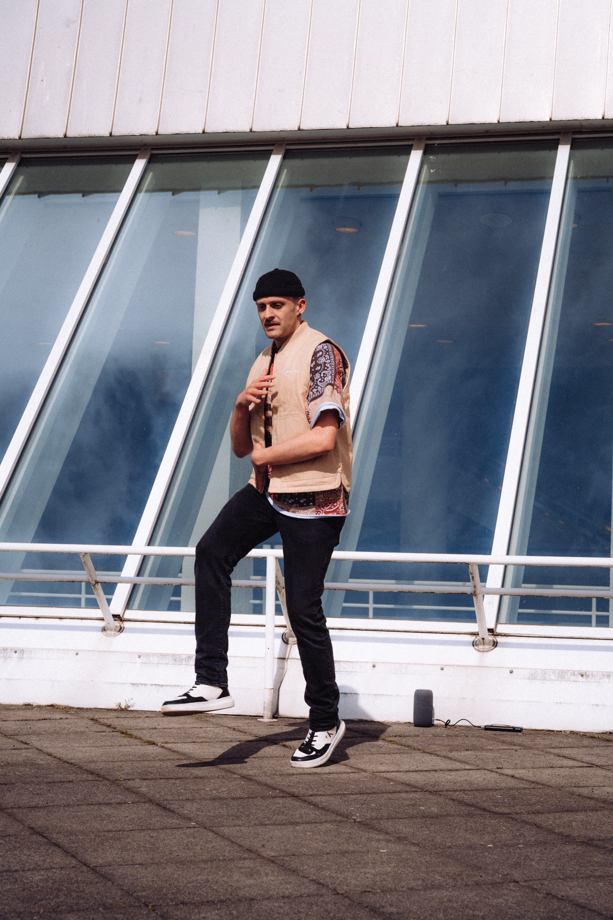 Stylish Man Posing Outside Modern Architecture · Free Stock Photo