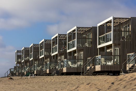 Stunning modern beach houses under a clear blue sky at Hoek van Holland, perfect for a summer getaway.