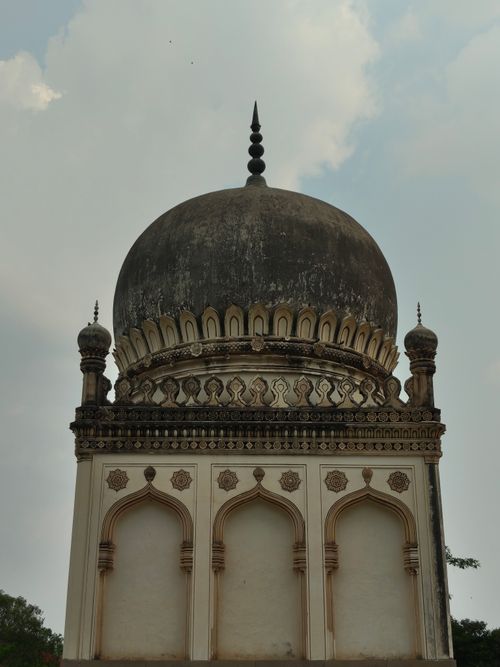 Free Intricate stonework of a Qutb Shahi tomb under a cloudy sky, Hyderabad, India. Stock Photo