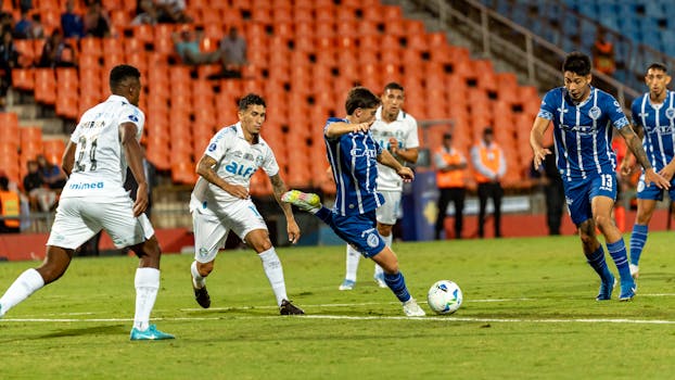 Dynamic action shot of a soccer match highlighting players in motion on the field during a competitive game.