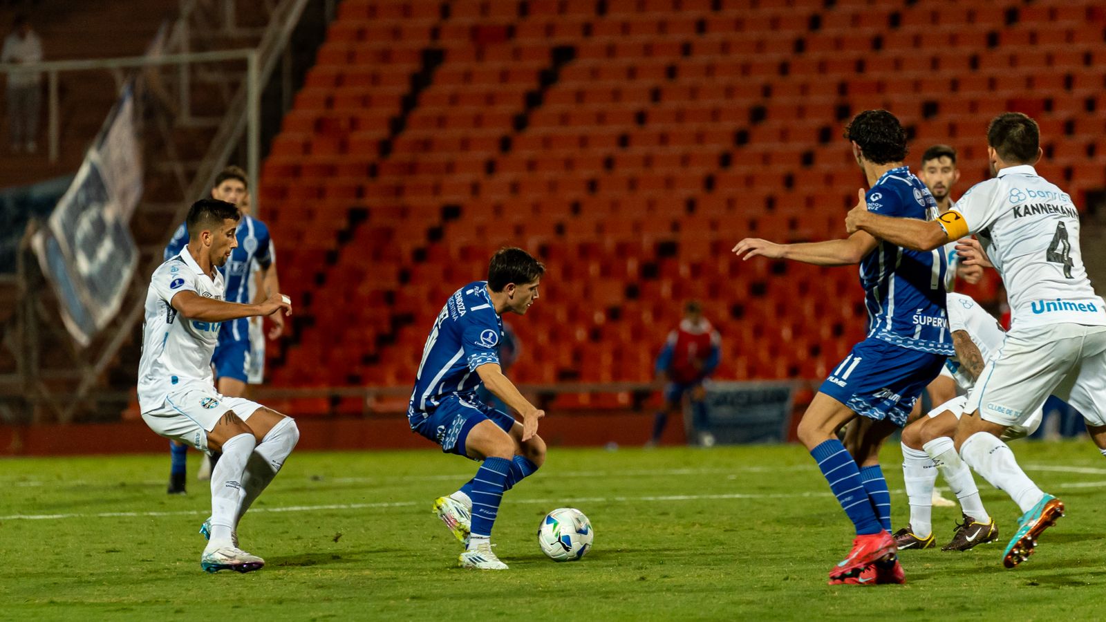 Action-Packed Football Match Under Stadium Lights · Free Stock Photo