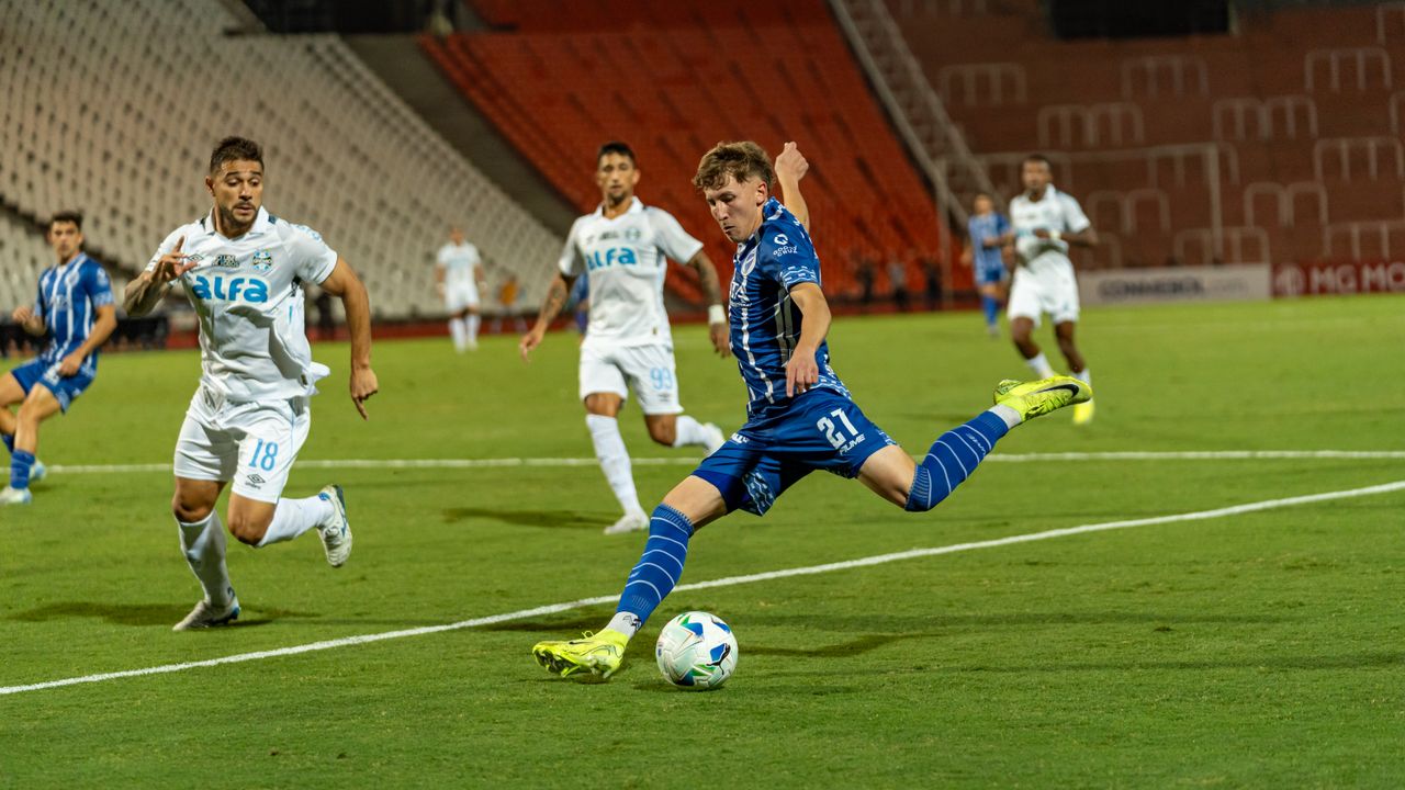 dynamic action shot of a soccer match with players in blue and white j