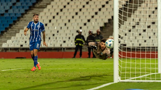 Goalkeeper making a spectacular save during a thrilling football match.