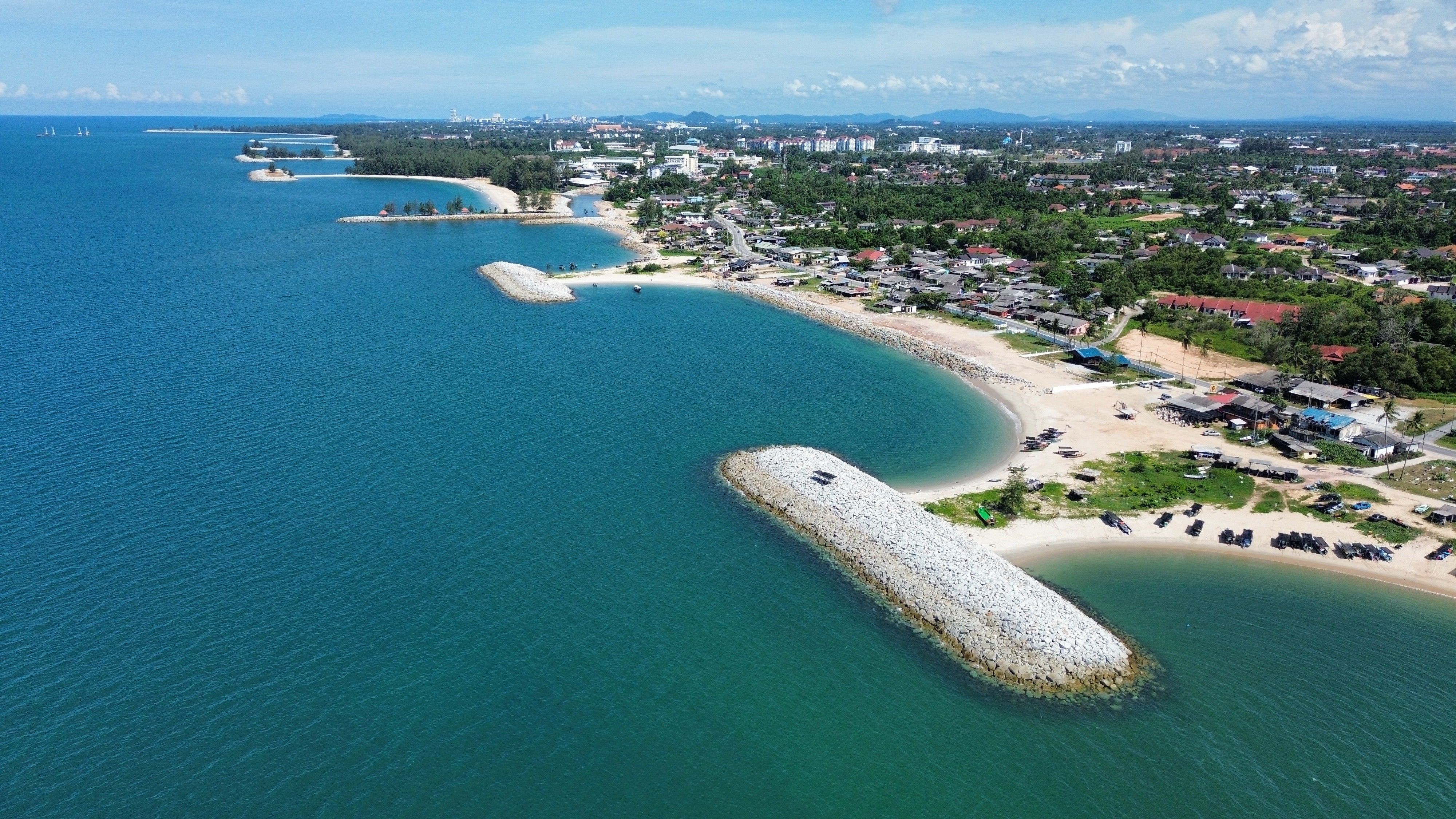 Scenic aerial view of Terengganu's serene coastline and azure waters in Malaysia.