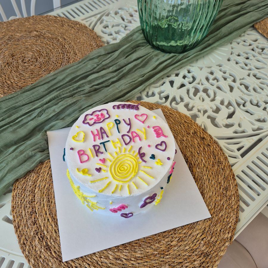A brightly decorated birthday cake with candles.