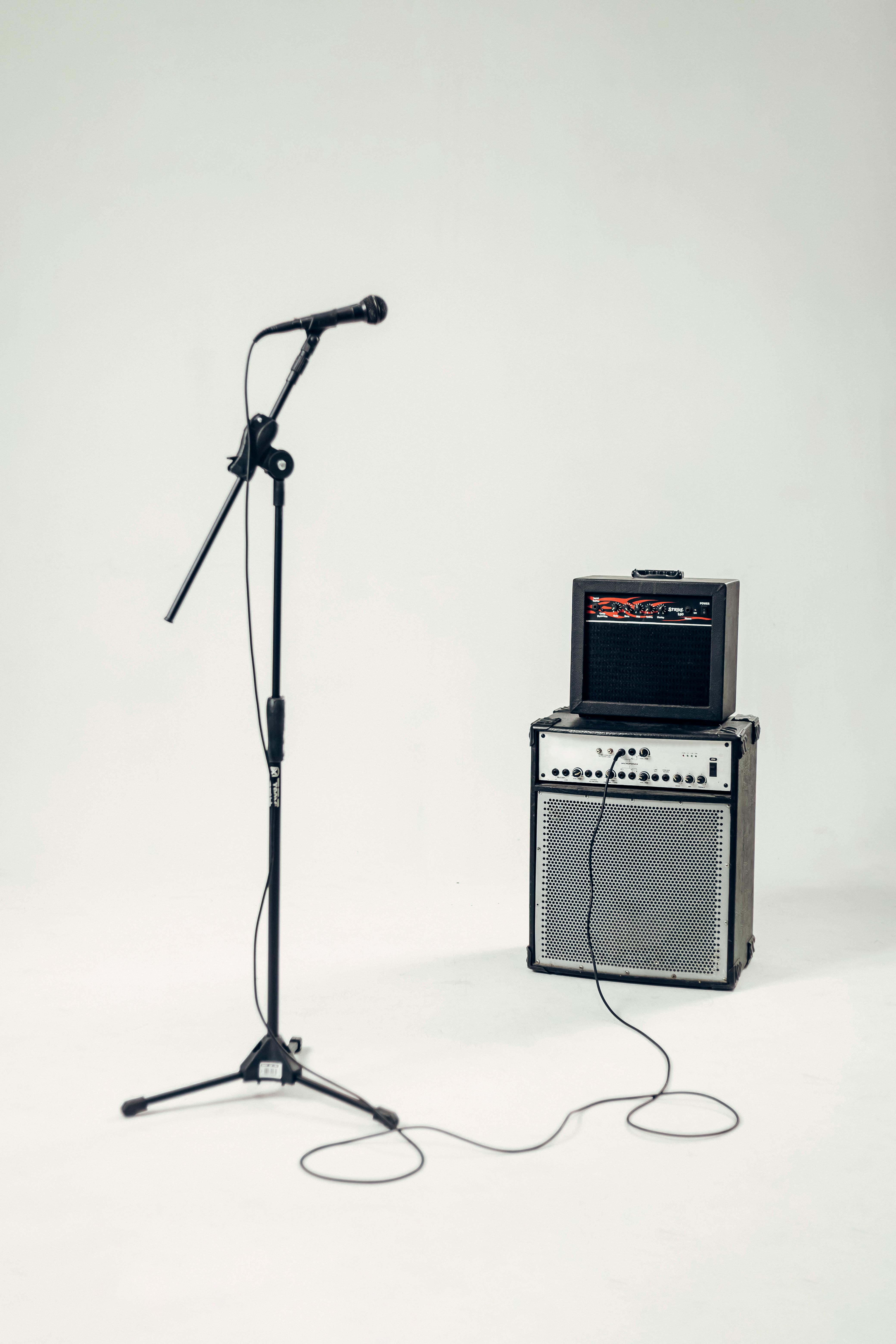 Minimalist setup with a microphone and amplifier in a studio environment.
