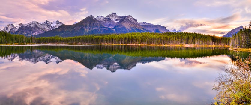 Beautiful reflection of mountains on Herbert Lake during sunset in Banff National Park, Canada.