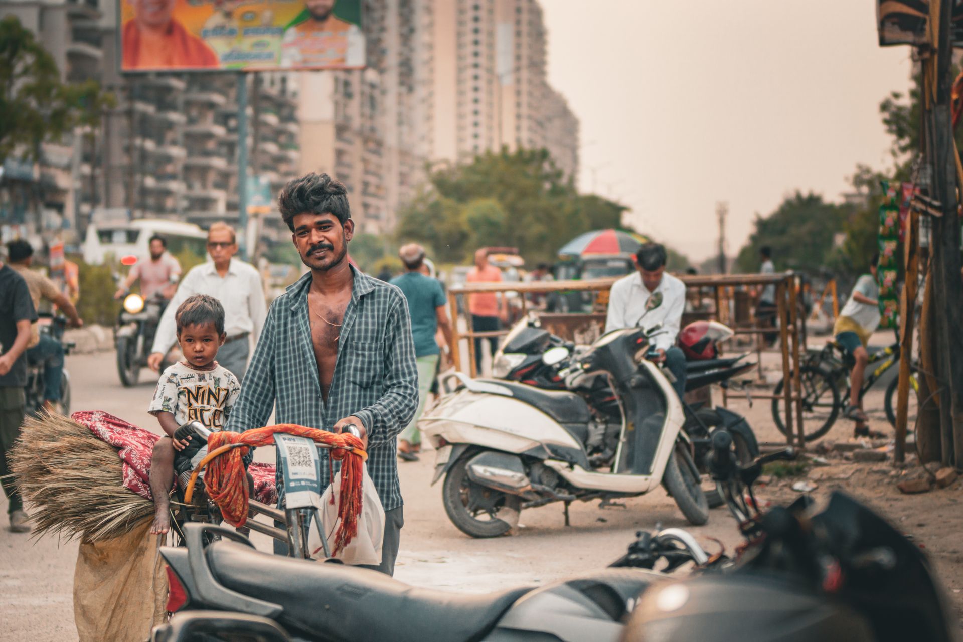A hardworking street vendor with a child on a busy urban road, reflecting daily life.